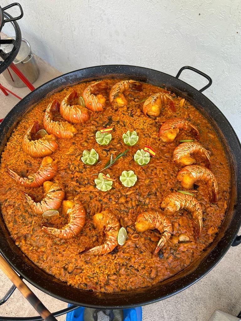 Paella with lobster tails and lime